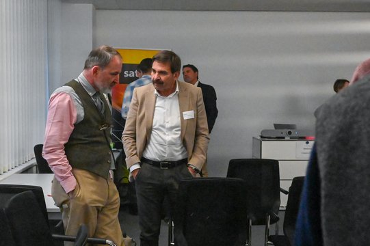 Two men in conversation in a modern office