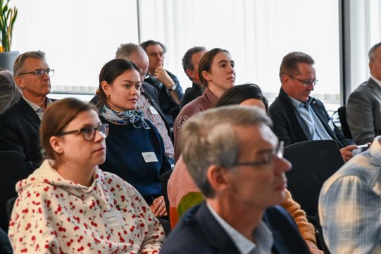 People in a conference room listening attentively